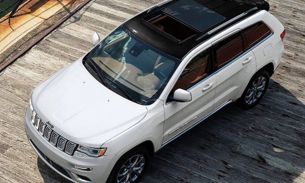A 2021 Jeep Grand Cherokee driving on a boardwalk
