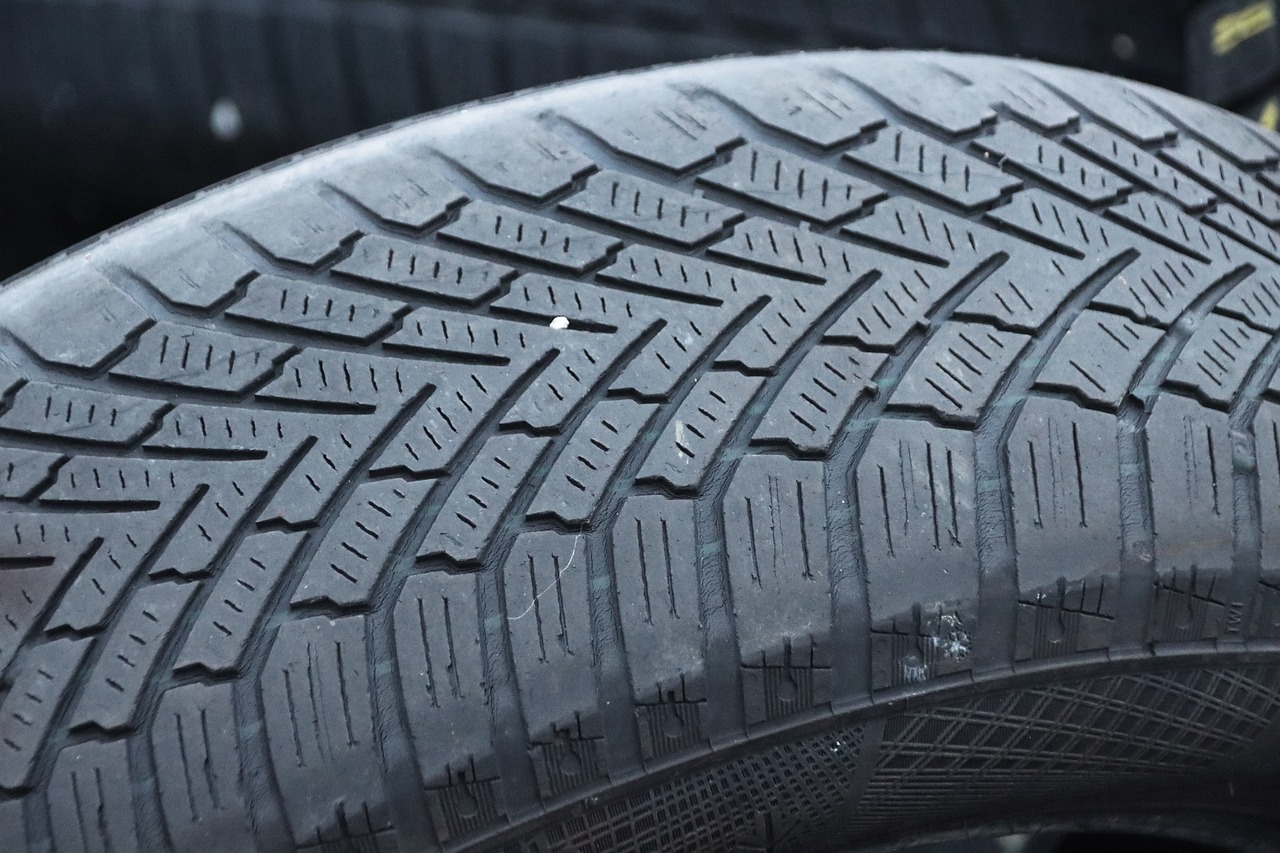 A close-up image of a tire with an emphasis on the texture of its tread