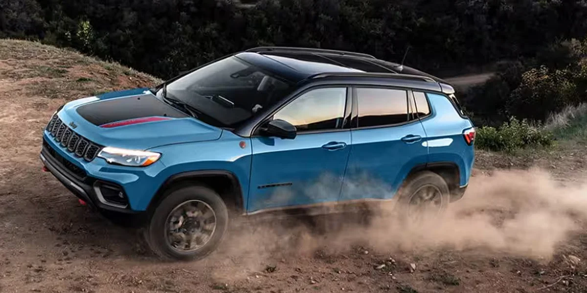 A 2025 Jeep Compass off-roading in the dirt