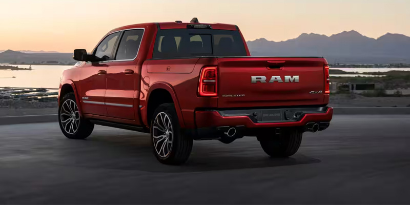 2026 RAM 1500 RHO parked on a rugged trail, showcasing its off-road suspension, aggressive stance, and high-performance design.